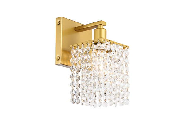 This Phineas Collection wall sconce exudes elegance and sparkling beauty. Why wouldn't it, with its beautiful curtain of clear crystal strands that shimmer with each passing second as light passes through? Your home will be illuminated and your guests will be charmed by these dancing crystal lights. And you'll be pleased with how this wall lamp can elevate any room into a luxurious and glamourous world.Made of crystal and iron | Glamourous and ritzy wall sconce sparkles with cool ease | Curtains of clear crystals | Light illuminates downwards (and is dimmable) | Uses E12 bulb (sold separately); compatible with LED bulbs | Easily mounted on wall | Easily mounted on wall | Assembly required | Imported