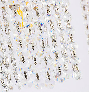 This Phineas Collection wall sconce exudes elegance and sparkling beauty. Why wouldn't it, with its beautiful curtain of clear crystal strands that shimmer with each passing second as light passes through? Your home will be illuminated and your guests will be charmed by the dancing crystal lights. You will be pleased with how this wall lamp can elevate any room into a luxurious and glamourous world.Made of crystal glass and iron | Glamourous and ritzy wall sconce will sparkle with cool ease | Curtains of clear crystals | 2 lights illuminate downward  | Uses E12 bulb (sold separately); compatible with LED bulbs | Easily mounted on wall | Dimmable | Assembly required | Imported