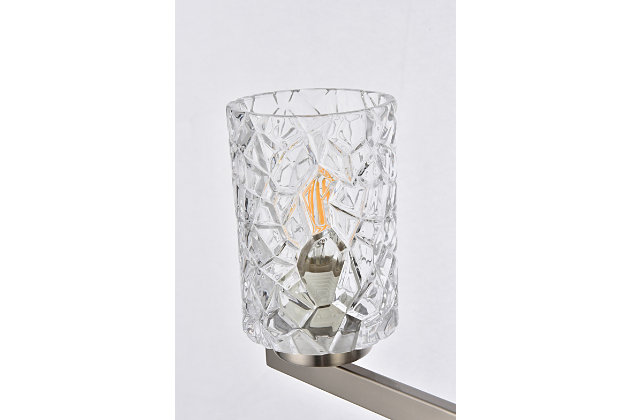 In all of its auspicious glory, the Cassie Collection wall sconce will shine its felicitous light for you. As the light passes through the shade, it dances around with the shadows and puts a spotlight in your room. Whether it's in your entryway or bathroom, this wall lamp will surely please you and your guests. Glass and metal with silvertone finish | Ideal for lighting the bathroom, hallway, and entryway | Easily mounted on the wall | Dimmable | Uses three E12 bulbs (sold separately) | No assembly required | Imported