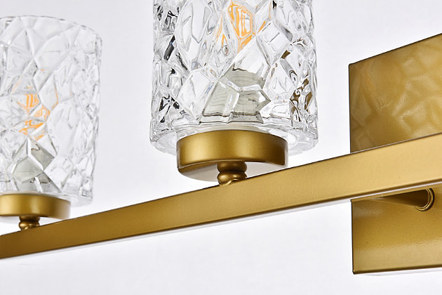 In all of its auspicious glory, the Cassie Collection wall sconce will shine its felicitous light for you. As the light passes through the shade, it dances around with the shadows and puts a spotlight in your room. Whether it's in your entryway or bathroom, this wall lamp will surely please you and your guests. Made of glass and metal | Ideal for lighting the bathroom, hallway, and entryway | Easily mounted on the wall | Dimmable | Uses four E12 bulbs (sold separately) | No assembly required | Imported