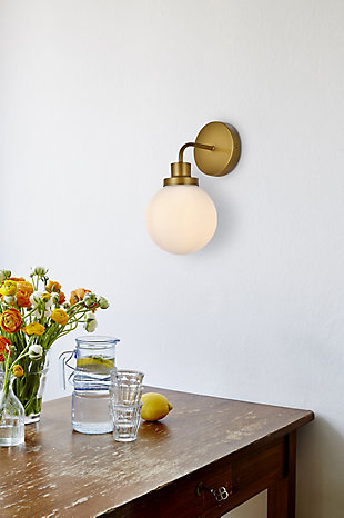 In all of its auspicious glory, the Hanson Collection wall lamp will shine its felicitous light for you. As the light passes through the shade, it dances around with the shadows and puts a spotlight in your room. Whether it's in your entryway or bathroom, this wall lamp will surely please you and your guests. Made of glass and metal | Ideal for lighting the bathroom, hallway, and entryway | Easily mounted on the wall | Dimmable | Uses E12 bulb (sold separately) | No assembly required | Imported