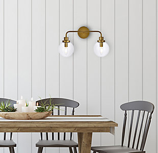 In all of its auspicious glory, the Hanson Collection wall lamp will shine its felicitous light for you. As the light passes through the shade, it dances around with the shadows and puts a spotlight in your room. Whether it's in your entryway or bathroom, this wall lamp will surely please you and your guests. Made of glass and metal | Ideal for lighting the bathroom, hallway, and entryway | Easily mounted on the wall | Dimmable | Uses two E12 bulbs (sold separately) | No assembly required | Imported