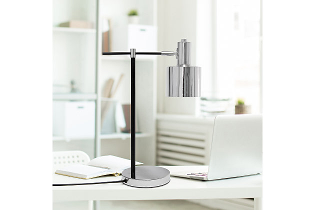 Illuminate your living space with this simple yet bold table lamp. It features a beautiful polished chrome finish with black accents. The perfect accent piece for your office, bedroom, foyer or living room.Polished chrome finish | Round metal shade | Modern and industrial | (1) 40w type a base bulb (not included) required | Easily accessible on/off switch on cord | 5 foot black cord