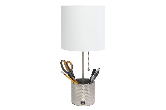 This fun and fashionable lamp features a brushed nickel hammered metal base and a white fabric shade. It comes equipped with a USB seated in the base for charging mobile phones, handheld games, tablets, and other small electronics. This lamp will add a fabulous flair to any room. Perfect for bedrooms, kids and teens, college dorms, nurseries, or fun offices.Brushed nickel base with usb charging port on base | White fabric shade | Perfect for bedrooms, kids room, college dorm, nursery, or fun office | Uses (1) 40w type a medium base bulb (not included) | Usb port on base for charging your phone or other device | Base includes storage for supplies