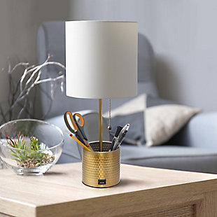 This fun and fashionable lamp features a gold hammered metal base and a white fabric shade. It comes equipped with a USB seated in the base for charging mobile phones, handheld games, tablets, and other small electronics. This lamp will add a fabulous flair to any room. Perfect for bedrooms, kids and teens, college dorms, nurseries, or fun offices.Gold base with usb charging port on base | White fabric shade | Perfect for bedrooms, kids room, college dorm, nursery, or fun office | Uses (1) 40w type a medium base bulb (not included) | Usb port on base for charging your phone or other device | Base includes storage for supplies