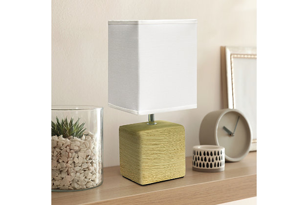 Clean and modern, this simple table lamp features a square faux stone base crafted from ceramic. The crisp, soft fabric shade adds a gentle touch to the textured base. Perfect for bedrooms, entryways, kids and teens, college dorms, nurseries, or offices.Beige faux stone base | White rectangular fabric shade | Trendy faux stone look | Uses (1) 40w type b e-12 candelabra base bulb (not included) | Easily accessible rotary switch located on the cord | Lamp is a mini lamp; please see details for height