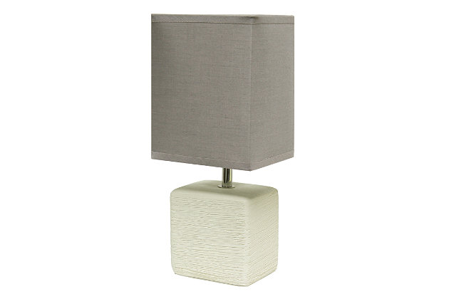 Clean and modern, this simple table lamp features a square faux stone base crafted from ceramic. The crisp, soft fabric shade adds a gentle touch to the textured base. Perfect for bedrooms, entryways, kids and teens, college dorms, nurseries, or offices.Off-white faux stone base | Gray rectangular fabric shade | Trendy faux stone look | Uses (1) 40w type b e-12 candelabra base bulb (not included) | Easily accessible rotary switch located on the cord | Lamp is a mini lamp; please see details for height
