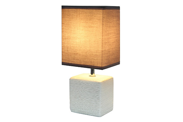Clean and modern, this simple table lamp features a square faux stone base crafted from ceramic. The crisp, soft fabric shade adds a gentle touch to the textured base. Perfect for bedrooms, entryways, kids and teens, college dorms, nurseries, or offices.Off-white faux stone base | Gray rectangular fabric shade | Trendy faux stone look | Uses (1) 40w type b e-12 candelabra base bulb (not included) | Easily accessible rotary switch located on the cord | Lamp is a mini lamp; please see details for height