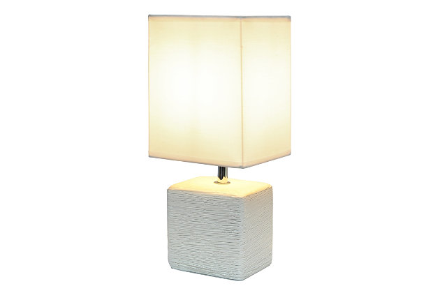 Clean and modern, this simple table lamp features a square faux stone base crafted from ceramic. The crisp, soft fabric shade adds a gentle touch to the textured base. Perfect for bedrooms, entryways, kids and teens, college dorms, nurseries, or offices.Off-white faux stone base | White rectangular fabric shade | Trendy faux stone look | Uses (1) 40w type b e-12 candelabra base bulb (not included) | Easily accessible rotary switch located on the cord | Lamp is a mini lamp; please see details for height