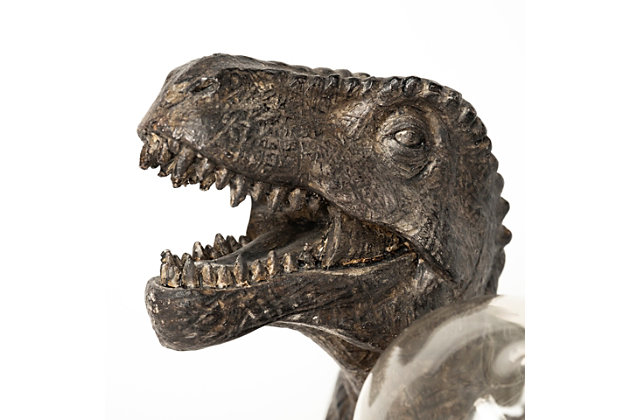 Attention dinosaur lovers. Crafted from resin with immaculate detail and dark brown and gray tones, this unique table lamp is inspired by the Tyrannosaurus Rex. This spectacular piece is not only visually enticing but also sturdy and substantial. This T-Rex has the ability to host one bulb that is held between its arms casting a warm and luminous glow wherever it's placed.Made of resin | Brown and gray finish | Single E26 bulb (not included); 60 watts max; UL Listed | Indoor use only | Assembly required | Imported