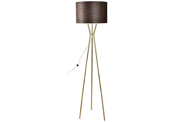 Embrace the power and beauty of the Emerson tripod floor lamp. It marries a sleek goldtone base with a taupe velvet drum shade for a brilliant look. Bringing light to your space in elegant style, this lamp is perfect for adding a final touch of contemporary charm.Made of iron with hardback drum velvet shade | Goldtone powder coat finish | On/off foot switch | 1 E26 socket; type A bulb recommended (not included); 150-watt max | Non-skid bottom | Power cord included; UL Listed | Assembly required