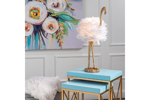 Fabulous and fashionable, this flamingo lamp will grab glances from everyone who sets foot in your home. A textured goldtone finish adorns the body, with a cluster of faux feathers operating as the shade and bird's body. It's sure to make a striking statement in your living room or bedroom.Made of resin with oval hardback faux feather shade | Goldtone finish | In-line switch | 1 E26 socket; type A bulb recommended (not included); 60-watt max | Non-skid bottom | Power cord included; UL Listed | Assembly required