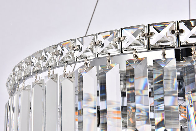 A riot of shapes and textures, Maxime collection hanging fixtures sparkle in a mosaic of crystal tiles. Square and rectangular precision-cut crystals form the flamboyant exterior while faceted crystal balls create a bubbled effect for light to shine through beneath. A mischievous asymmetrical hanging tube adds a touch of whimsy to this structured design. Available in a chrome finish with clear or golden-teak crystals, these lamps are a luxurious addition to a dining room, stairwell, foyer, or living room. Room use: Dining room; Living room; Bedroom; Bathroom; Entry Way; Closet | Diameter of 24 inches; minimum hanging height of 27 inches, maximum hanging height of 80 inches. | Warm, brilliant light is created by 12 light bulbs. (not included) | comes with an adjustable hanging cable