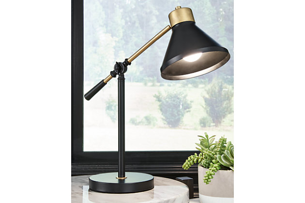 Black and metallic tones make the Garville desk lamp understated but refined. The adjustable neck and shade cast light in the direction of interest. Whether you're completing a homework assignment or pursuing the online news, this lamp is the perfect desk companion. Made of metal with metal shade | Black and goldtone finish | Adjustable height and direction | On/off switch | 1 E26 socket; type A bulb recommended (not included); 40 watts max or CFL 8 watts max; UL Listed | Assembly required | Estimated Assembly Time: 15 Minutes
