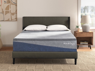 Molecule Reflex mattress on bed with nightstand and pillows in a bedroom setup