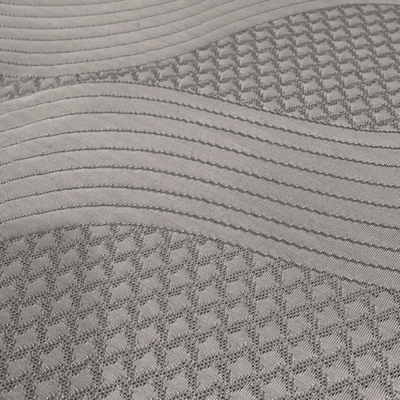Close-up of mattress quilting pattern with wavy lines