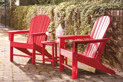 Add cottage-quaint charm to your outdoor oasis with the Sundown Treasure 3-piece outdoor set in red. Made of a hearty hard plastic material with a touch of texture, it’s sure to weather the seasons beautifully. Designed to shed rainwater, the chair and table’s slatted styling provides exceptional form and function.Includes 2 Adirondack chairs and 1 end table | Chair and table made of virgin high-density polyethylene (hard plastic) material | Chair and table with red finish | Chair and table with textured grain finish | Chair and table slatted design | No assembly required | Estimated Assembly Time: 75 Minutes