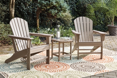 Add cottage-quaint charm to your outdoor oasis with the Sundown Treasure 3-piece outdoor set. Made of a hearty hard plastic material with a touch of texture and driftwood color, it’s sure to weather the seasons beautifully. Designed to shed rainwater, the chair and table’s slatted styling provides exceptional form and function.Includes 2 Adirondack chairs and 1 end table | Chair and table made of virgin high-density polyethylene (hard plastic) material | Chair and table with brown/beige finish | Chair and table with textured grain finish | Chair and table slatted design | No assembly required | Estimated Assembly Time: 75 Minutes