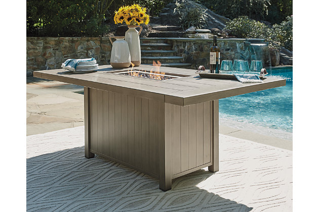 Inspired by high-style modern farmhouse interiors, the Windon Barn rectangular fire table conveys a warmth and sophistication that’s just your style. The table’s plank-effect details and easy-on-the-eyes light brown hue exude a sense of easy elegance. What really puts on a show—the way the fire table’s flickering flame seems to float on a bed of clear glass beads. Best of all, this quality crafted outdoor table with multistep, wood-look finish is made of rust-free aluminum for lots of seasons in the sun.Rust-free aluminum frame with multistep, wood-look finish | Brown tone | CSA-approved 30,000 BTU stainless steel burner with glass beads | Table comes with burner cover and protective weather cover | Door conceals gas propane tank (not included) | Convertible to natural gas | Assembly required | Assembly of fire pit table provided with in-home delivery; connection to propane tank or connector hose not provided | Estimated Assembly Time: 45 Minutes
