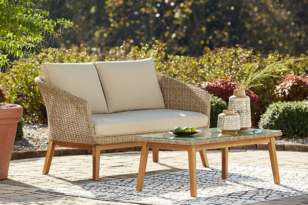 Turn your outdoor space into a high-style hideaway with the Crystal Cave 2-piece outdoor loveseat and table set. Clearly for those with an eye for fine design, this sleek, chic outdoor furniture set is quality made to withstand the elements. What looks like traditional wicker is the next best thing: resin wicker woven over rust-proof aluminum for exceptional durability and worry-free living. Acacia wood legs, a tempered glass tabletop and easy-breezy Nuvella®/olefin wrapped cushions enhance its appeal. 2-piece outdoor furniture set includes loveseat and coffee table | Made of resin wicker woven over aluminum frames | Table with tempered glass top | Acacia wood legs | Cushions covered in solution-dyed Nuvella® (olefin) high-performance fabric | All-weather foam cushion core wrapped in soft polyester | Clean fabric with mild soap and water, let air dry; for stubborn stains, use a solution of 1 cup bleach to 1 gallon water | Imported fabric and fill | Assembly required | Estimated Assembly Time: 30 Minutes