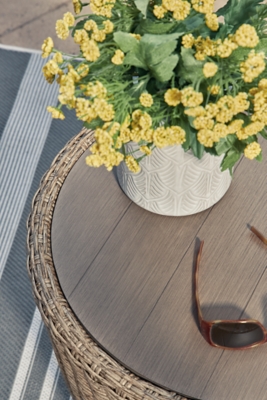 Side view of round wicker outdoor end table with dark gray wood-look top