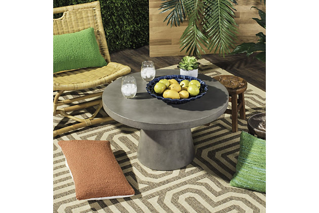 The rooftop lounge atop Berlin’s foremost art gallery inspired this concrete round indoor-outdoor coffee table. Its dark gray hue and luxurious materiality lend character to any contemporary interior. Ideal for outdoor entertaining or a grand living room.Made of concrete | Suitable for indoor/outdoor use | Spills should be taken care of immediately before they stain; do not use bleach solutions | Weight capacity 15 lbs