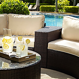 This outdoor wicker arm table with modular design helps create an outdoor oasis right in your own backyard. Constructed of all-weather resin wicker elegantly woven over a durable powder-coated steel frame, the tabletop opens to a storage compartment perfect for summer essentials. Both stylish and functional, this outdoor table is the perfect complement to your outdoor space.Durable powdercoated steel frame | All-weather resin wicker with rattan look | Hinged tabletop opens to storage compartment | Assembly required