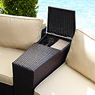 This outdoor wicker arm table with modular design helps create an outdoor oasis right in your own backyard. Constructed of all-weather resin wicker elegantly woven over a durable powder-coated steel frame, the tabletop opens to a storage compartment perfect for summer essentials. Both stylish and functional, this outdoor table is the perfect complement to your outdoor space.Durable powdercoated steel frame | All-weather resin wicker with rattan look | Hinged tabletop opens to storage compartment | Assembly required
