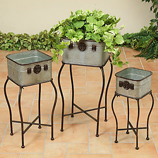Add style and antiquity to your outdoor scene or garden with this classically designed set of three plant holders. Set Contains Assorted Sizes: Large Stand is 13.38InL by 27.75InH, Medium Stand is 11.02InL by 23.22InH, and Small Stand is 8.46InL by 19.29InH. Artfully crafted of galvanized metal, each square planter is accented with an antique styled latches on the front. Each planter also includes a four-prong metal stand, allowing you to choose how best to display your favorite floral arrangements: Place them together to make an outstanding centerpiece attraction, or separate them to add a beautiful accent to several areas of your home. Use these plant holders to house your favorite flowers or potted plants either in your home or garden, or to liven up your patio with a classic style that your guests will envy.Made of metal | Set of 3 classically-styled plant holders with stands | Set comes in three sizes: large stand is 13.38inl by 27.75inh, medium stand is 11.02inl by 23.22inh, and small stand is 8.46inl by 19.29inh | Artfully-crafted with galvanized metal, these planters are square with antique metal latches affixed to the front | Artfully-crafted with galvanized metal, these planters are square with antique metal latches affixed to the front | Durably-constructed of iron and built to last a lifetime, use these planters to house your favorite plants year-round | Light assembly is required to attach the legs with everything needed included | Assembly required