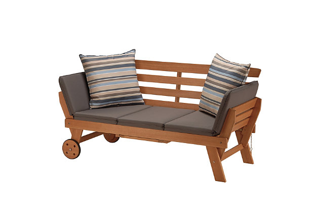 This indoor/outdoor daybed is constructed of FSC Eucalyptus, a sustainable, eco-friendly wood sourced from managed forests and certified by the Forest Stewardship Council. It is naturally weather-resistant and its inherent oil content will protect against moisture, UV rays, decay and rot. This functional and attractive lounger features a classic slatted design, with removable/tie-down five section seat and side cushion padding. Backrest includes two decorative complimenting color striped cushions. Strong polyester fabric cushion covers are water, stain, mildew and fade-resistant. Both side panels can be adjusted to provide a complete lay flat surface. Slide out tray table and easy transport wheels add convenience and mobility. This finely crafted wood furniture is perfect for use on porch, patio, yard or poolside.Dimensions: 75"L x 27"W x 30"H | FSC (Forest Stewardship Council) Certified | Highest quality Eucalyptus Grandis wood | Galvanized steel hardware | Slatted wood design | Side panels adjust for lay flat position | Pull out tray table and convenient wheels | Weather-resistant slate gray removable seat cushion & striped throw pillows