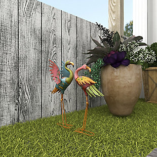 Add coastal flair to your home with this vibrant set of two flamingo sculptures. These figurines are bound to impress your guests with their marvelous design and uniqueness. Made of iron and showcasing impressive hand-painted floral patterns and multicolor finishes, each feathered friend features detailed characteristics and metal feet that serve as a sturdy base. What a charming way to add an artistic twist to your favorite indoor or outdoor spaces. Set of 2 flamingo sculptures | Features a coastal-inspired design for a laid-back vibe | Iron construction results in a long-lasting design for your outdoor space | The sculptures display a brilliant color palette; bright pink, yellow, blue, green and red finishes | Suitable for indoor and outdoor use | Wipe clean with a dry cloth | Items measure 18"L x 7"W x 32"H and 17"L x 7"W x 28"H; weight: 4.4 lbs.
