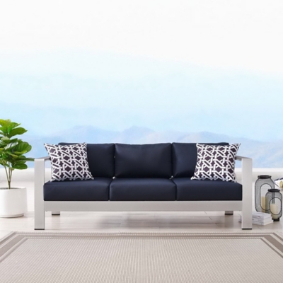 Outdoor sofa with navy cushions in a bright setting