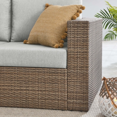 Pillow and side table arrangement on Convene outdoor loveseat