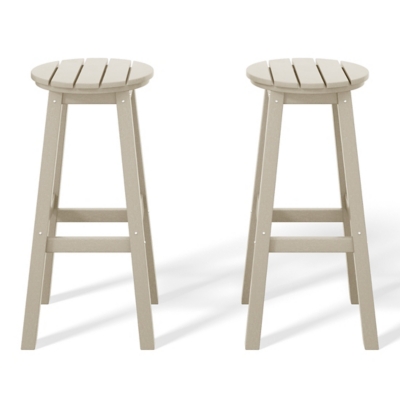 Close-up of two beige round-top bar stools