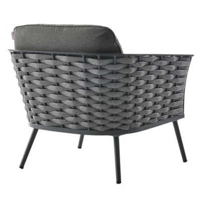 Rearm view of outdoor chair showing woven back and metal legs.
