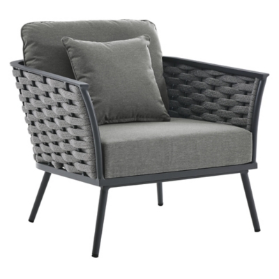 Close-up of an armchair from the outdoor set with gray cushions and dark woven sides.