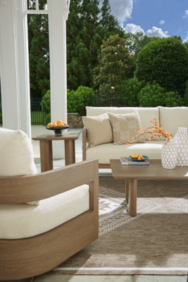 Outdoor seating arrangement with two sofas and a coffee table on patio