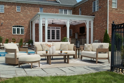 Wide view of backyard patio with seating area and pergola