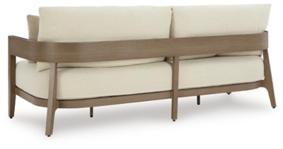 Beige outdoor sofa set with two armchairs and a coffee table by a pool
