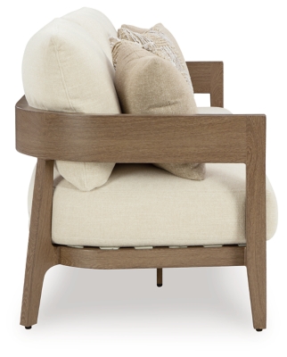 Side view of a wooden-framed beige outdoor sofa with cushions