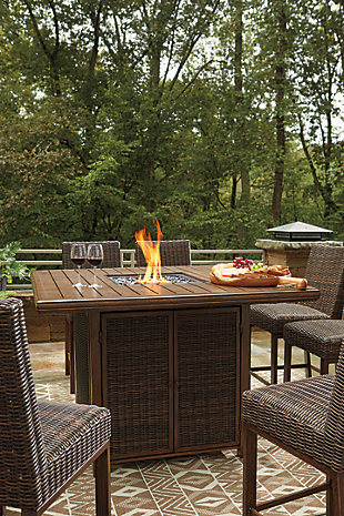 Turn your backyard space into your own piece of paradise with the Paradise Trail 7-piece outdoor fire pit table set. Though this outdoor table looks remarkably like wood, it’s made of sturdy, rust-proof aluminum that’s perfectly suited for al fresco living. Enhancing the rustically refined aesthetic: all-weather, handwoven resin wicker. The result may look high maintenance, but rest assured, this outdoor fire pit table set is anything but. With the press of a button, ignite a flickering flame that dances over a bed of glass beads. And with six high-style bar stools, it’s one highly accommodating outdoor bar table set.Includes square bar table with fire pit and 6 bar stools | Bar stools with all-weather, handwoven resin wicker over rust-proof aluminum frame; legs with wood-like finish | Fire pit table with rust-proof aluminum frame, wood-look tabletop and side panels accented with all-weather, handwoven resin wicker | 56" square fire pit table with CSA-approved 50,000 BTU stainless steel burner, glass beads, burner cover and enclosed storage area with shelves | Battery-operated ignition system with adjustable flame control; battery included | Convertible to natural gas | Table comes with protective weather cover | Door conceals gas propane tank (not included) | Assembly of fire pit table provided with in-home delivery; connection to propane tank or connector hose not provided | Estimated Assembly Time: 150 Minutes