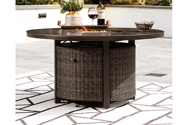 Turn your backyard space into your own piece of paradise with the Paradise Trail outdoor fire pit table. Though this outdoor table looks remarkably like wood, it’s made of sturdy, rust-proof aluminum that’s perfectly suited for al fresco living. Enhancing the rustically refined aesthetic: side panels accented with all-weather, handwoven resin wicker. The result may look high maintenance, but rest assured, this outdoor piece is anything but. With the press of a button, ignite a flickering flame that dances over a bed of glass beads. And with room for four, it’s one highly accommodating outdoor fire pit table.48" round fire pit with CSA-approved 55,000 BTU stainless steel burner, glass beads, burner cover and protective all-weather cover | All-weather, handwoven resin wicker over rust-free aluminum frame | Aluminum wood-look top | Door conceals gas propane tank (not included) | Convertible to natural gas | Battery-operated ignition system with adjustable flame control; battery included | Assembly required | Assembly of fire pit table provided with in-home delivery; connection to propane tank or connector hose not provided | Estimated Assembly Time: 45 Minutes