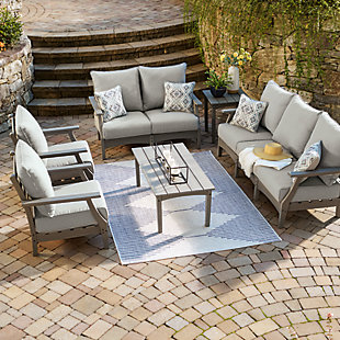 It’s the dawn of a new day for gray. Embrace the style trend with the Visola outdoor set. Each piece is crafted of HDPE material, combining the exceptional durability and weather resistance you need with the “wood look” you love. The tables and comfortably cushioned seats take alfresco living to a whole new level. Slatted table tops infuse a plank-style, farmhouse-inspired touch and naturally shed rainwater. Rest assured, the thick cushions on the sofa, loveseat and lounge chairs are wrapped in Nuvella® high-performance fabric that’s fade-resistant, stain-resistant and a breeze to keep clean.Includes sofa, loveseat, 2 lounge chairs, coffee table and end table | Made of durable and sturdy HDPE material | Gray finish with textured wood look | Stainless steel hardware | Throw pillows included | Seat/back cushions and pillows covered in solution-dyed Nuvella® (polyester) high-performance fabric | All-weather foam cushion core wrapped in soft polyester | Slatted table top | Clean fabric with mild soap and water, let air dry; for stubborn stains, use a solution of 1 cup bleach to 1 gallon water | Designed to withstand the harsh elements of the outdoors | Imported fabric and fill | Assembly required | Estimated Assembly Time: 135 Minutes