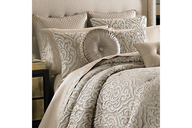 Traditional meets modern with the Astoria comforter set from J. Queen New York. The taupe ground of the comforter and shams sets the stage for this large scale damask pattern that creates a unique three dimensional effect, while the bed skirt offers a split corner diamond coordinate pattern and the hidden zipper pillow shams feature the damask motif in the center of each for a finished decorator look.100% polyester | Beige | Comforter set includes: 1 comforter, 2 pillow shams, 1 bed skirt | Made with design house quality fabric and craftsmanship | Timeless take on traditional patterns with an updated color palette | Dry clean only | Imported | Polyester fill