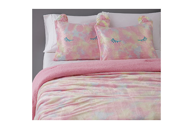 Bring a little fun into your room with this tie-dye rainbow bedding pattern. The face is a random print on velvet cloth, and the reverse of the comforter is a solid plush marshmallow fleece in solid pink. The fun is all in the shams, with sleeping eyes and pointy fleece ears on the corners. You'll drift off to sleep dreaming of colorful rainbows while snuggled warmly under this comforter set.Set includes 1 comforter and 1 pillow sham | Made of polyester | Pink, yellow and blue | Two-sided texture (velvet front; sherpa back) | Machine washable | Reversible to solid pink | Machine washable | Imported