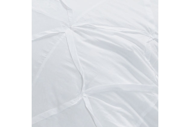 White nights. Sure to bring a boutique hotel element to your home, this quilt in brilliant white is a fresh style awakening. While the look and cottony soft feel are so luxurious, rest assured this quilt is machine washable for easy-breezy living.100% cotton face  | Hand-guided machine quilting in a diamond pattern and hand-tucked pleating  | Machine wash cold, gentle cycle, tumble dry low, do not bleach | Imported | Polyester fill | Shams not included