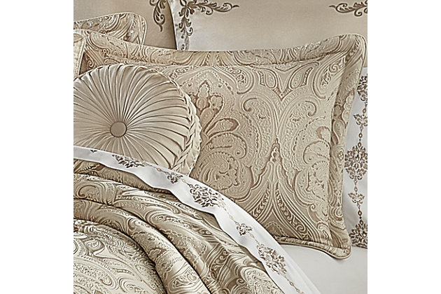 The Trinity 4 Piece Comforter Set is luxurious and beautifully crafted with a woven damask jacquard fabric in lovely tones of champagne. The damask pattern features a light champagne outline to give a unique three-dimensional look. Paired with matching pillow shams with hidden zippers and a solid champagne split-corner bed skirt with a 3 inch decorative woven jacquard stripe border along the bottom edge, this oversized ensemble will add a statement to your bedroom decor. The comforter is finished with a champagne piping for added detail. Coordinate window treatments, shams, and throw pillows are also available and sold separately to complete the look.Comforter Set Includes: 1 Comforter, 2 Pillow Shams, 1 Bedskirt. | Made with design house quality fabric and craftsmanship. | Timeless take on traditional patterns with an updated color palette. | Pair this Trinity bedding collection with the Euro Sham, Throw Pillows, and Window Treatments by J. Queen for a complete look.