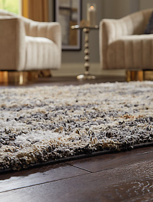 The Vinmore accent rug features a mix of design and color that is sure to breathe life into any room in your home. The tan and gray palette serves up a striking, eye catching aesthetic that is sure to be the focal point in your space.Made of polyester | Hand tufted | 12mm pile | Cotton backing | Rug pad recommended | Spot clean only | Imported