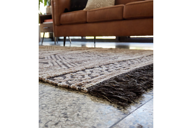 Dare to be different. Warm up your classic decor with the Kylin tribal-inspired area rug. This rug features a taupe and black palette with flirty fringe accents that add a bit of rustic flair to the flatwoven construction.Made of polyester/wool | Backed with cotton | Handwoven jacquard | No pile | Spot clean only | Rug pad recommended | Imported