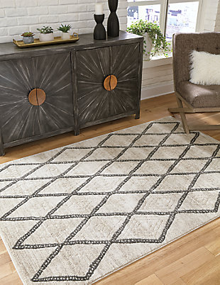 If you’re looking for contemporary style where you walk, the Jarmo rug delivers. Donning a beautiful gate design in shades of gray, cream and taupe, you’ll love how the soft pile feels on your feet—and how it matches with almost any color palette.Made of polypropylene | Machine woven | 11mm pile | Jute backing | Rug pad recommended | Spot clean only | Made in USA